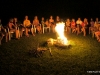 Girls gathered around the campfire at night