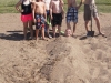 Burying their friend in the sand
